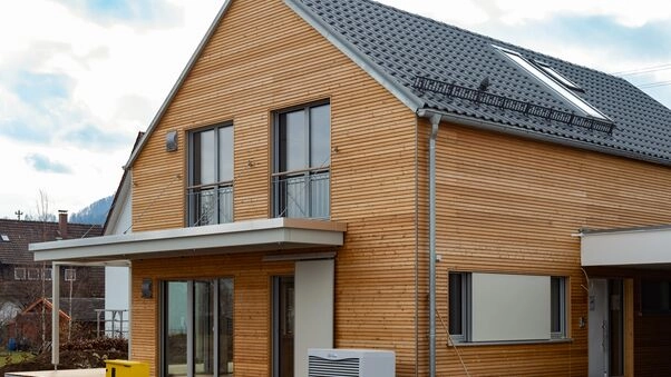 Symboldbild für das KfW-Programm 261: Ein Einfamilienhaus mit Holzfassade.